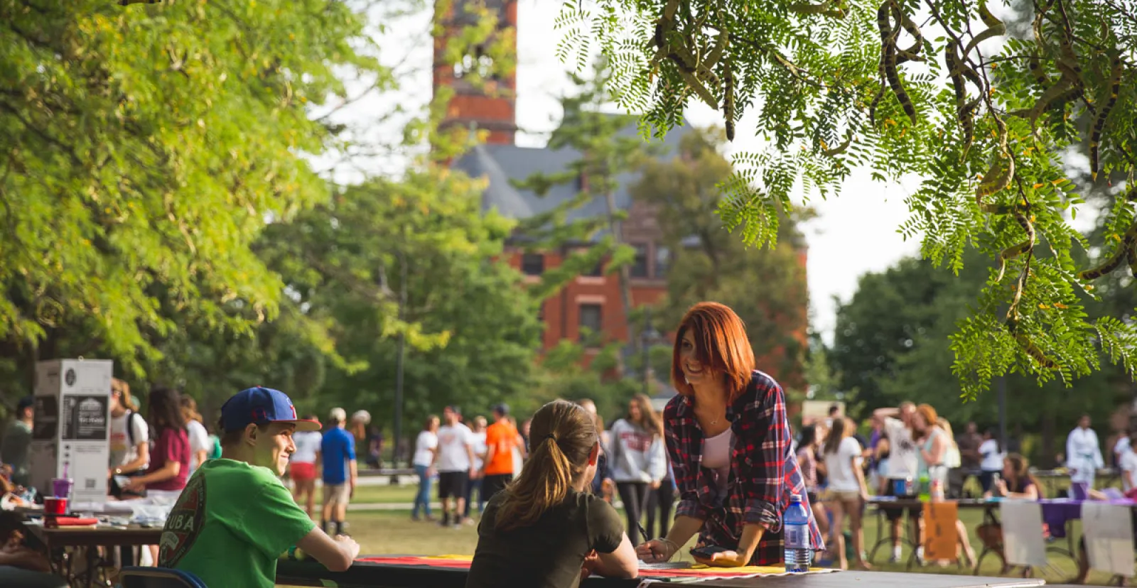 busy outdoor tabling event with Glatfelter hall in background