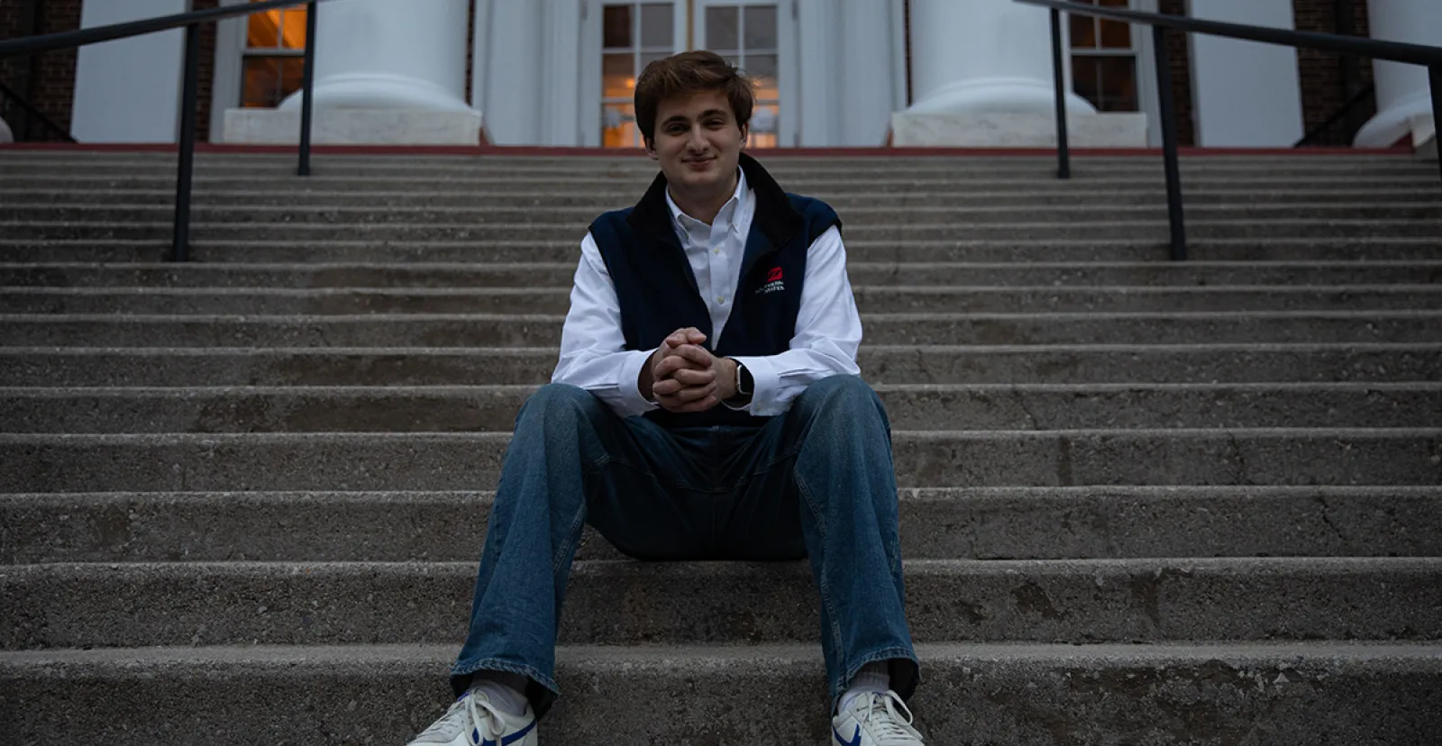 male alum sitting on concrete steps