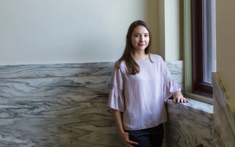 Haley Shultz standing in a hallway inside of Glatfelter Hall