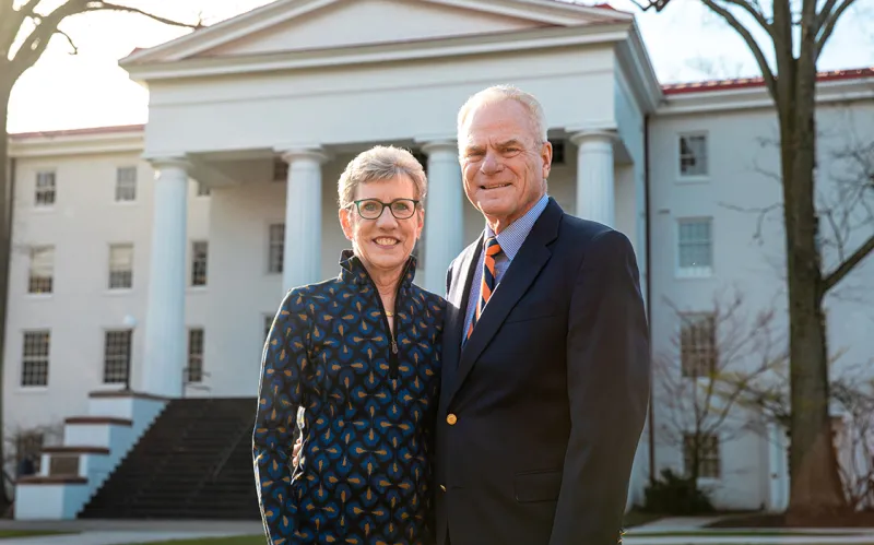 Joan ’76 and Rick Schweizer ’76 in front of Penn Hall