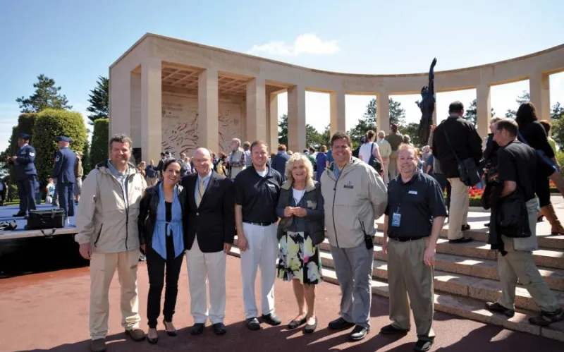 group of people smile at military event