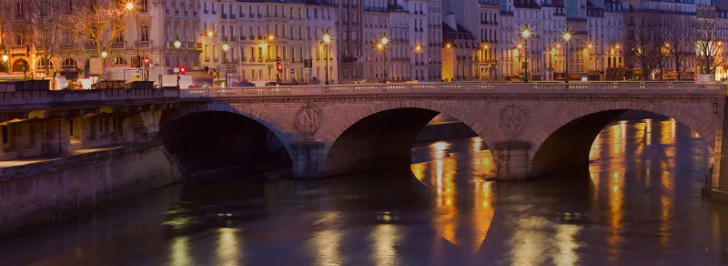 stone bridge over river at night