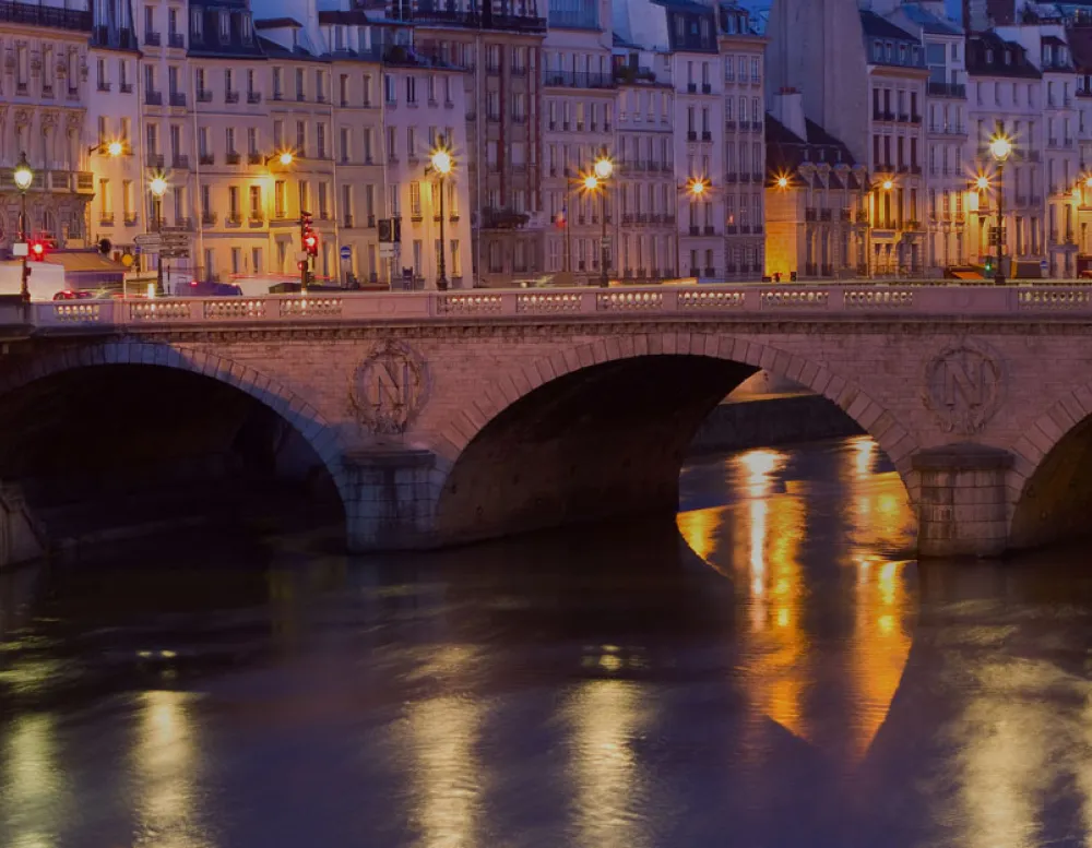 stone bridge over river at night